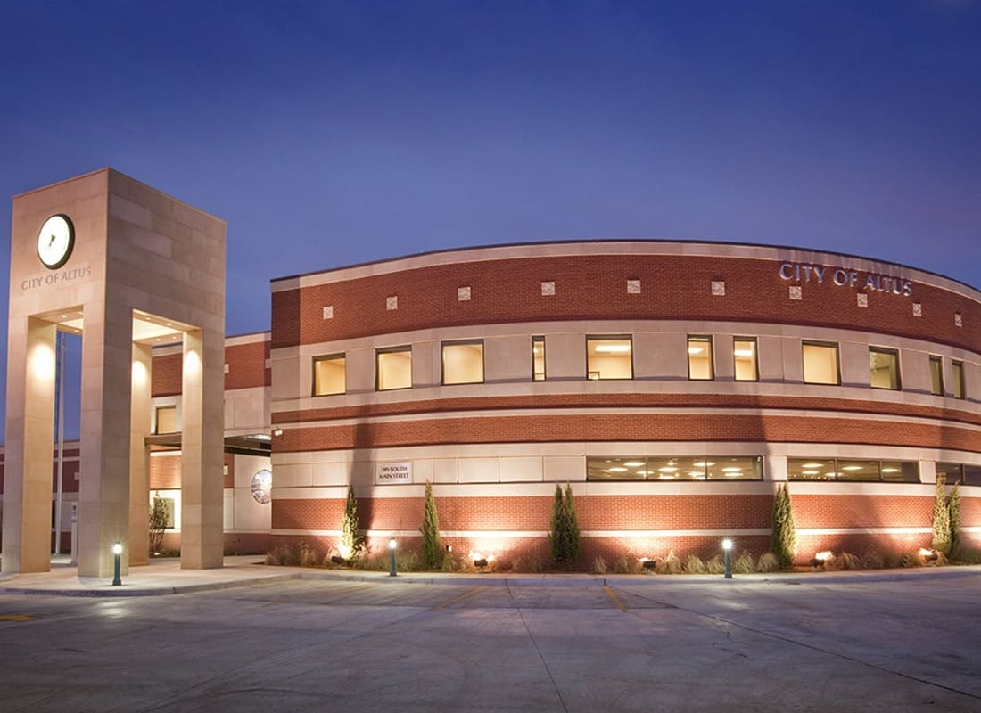 Altus, OK - Exterior View of the City of Altus Building in the Evening with the Lights on in Altus Oklahoma